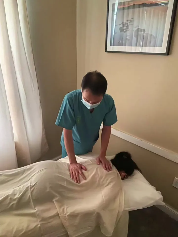 Therapist giving a back massage to a client